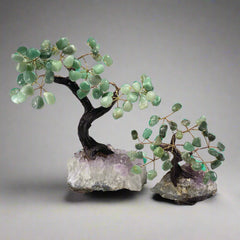 Two gemstone bonsai trees with green quartz leaves, set on amethyst crystal bases with wire trunks and branches.