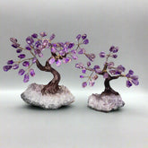 Two amethyst crystal trees on a gray background