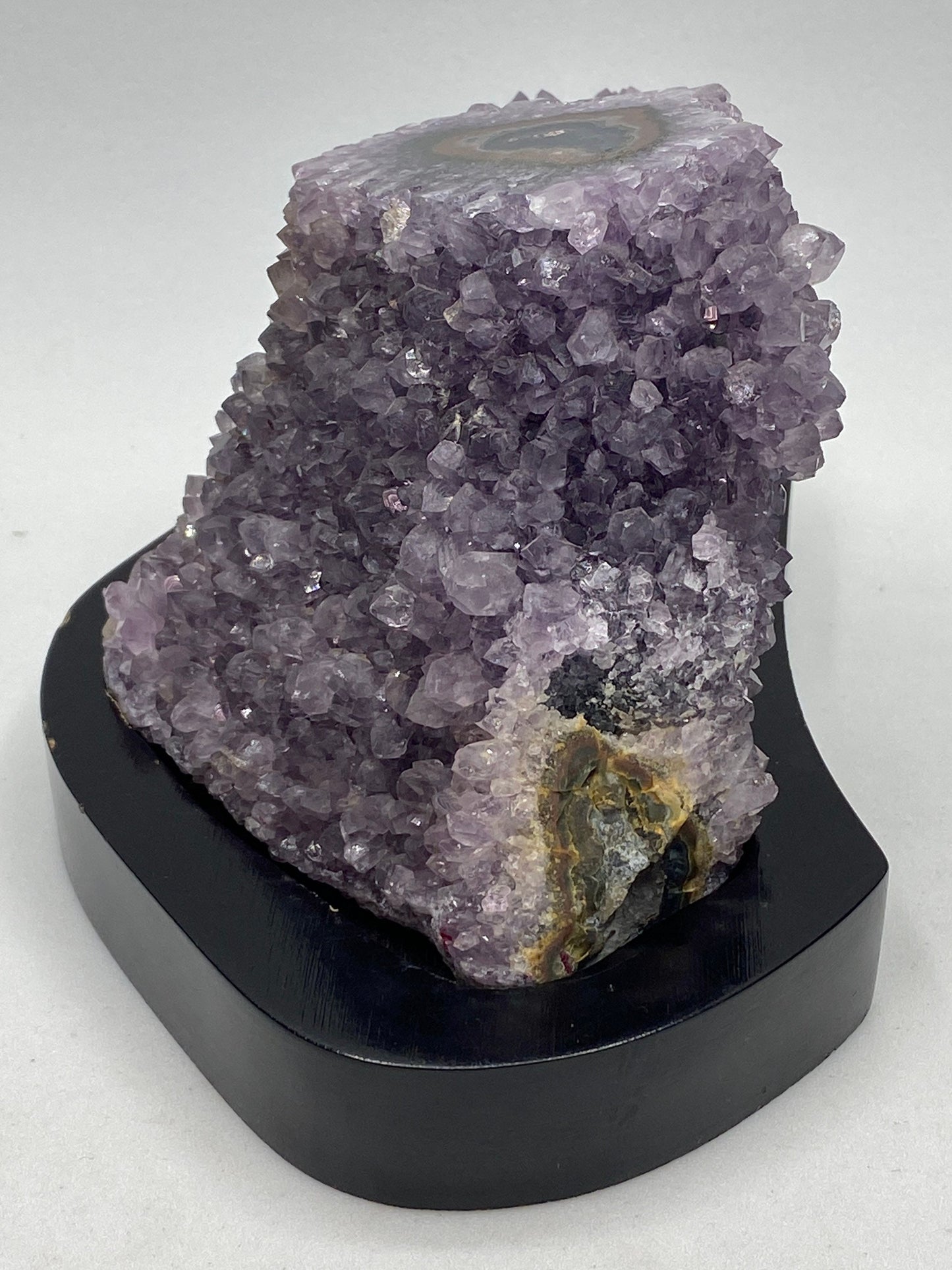 Amethyst geode stalagmite on a wood base