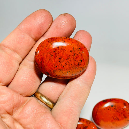 Polished oval red jasper cabinet knob with speckled stone face and silver nickel base