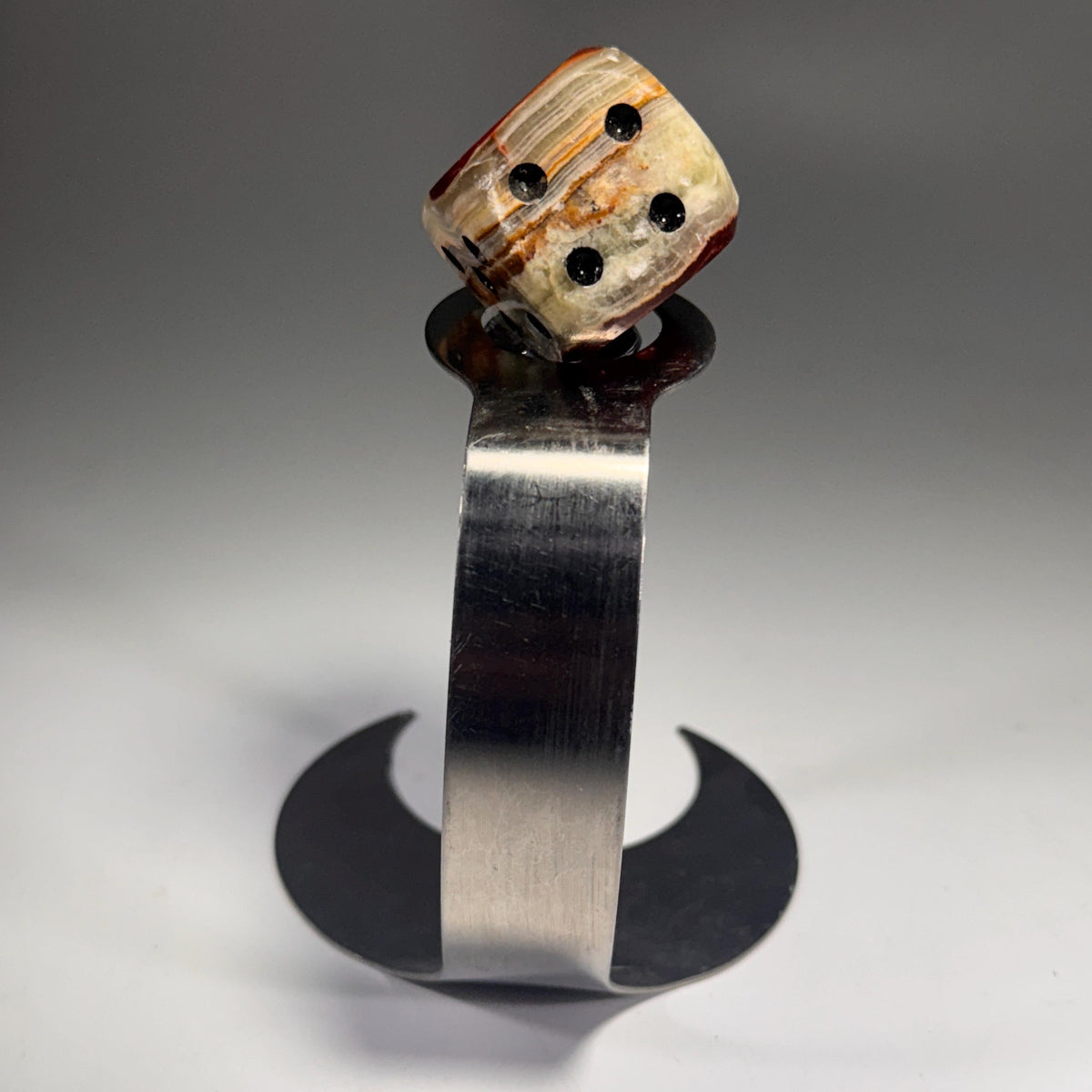 Dice bottle stopper with face-up dice top and stainless metal holder with cutout
