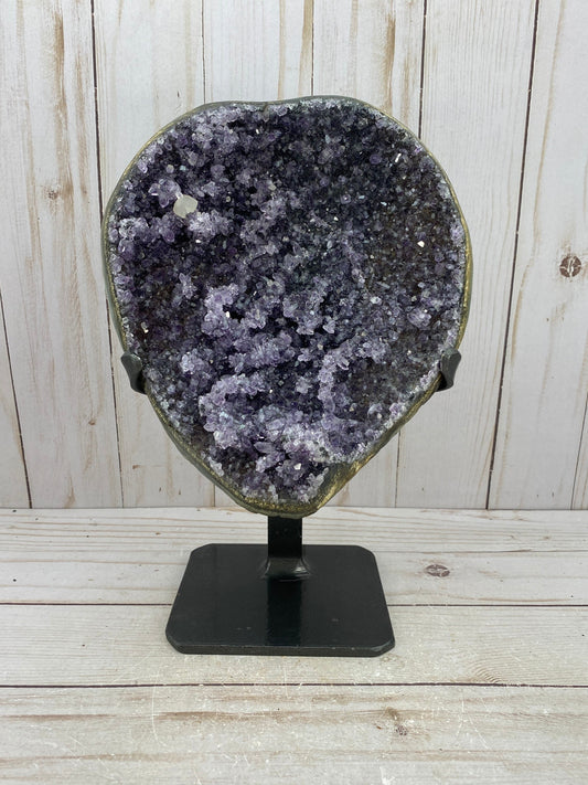 Amethyst geode cluster in metal stand