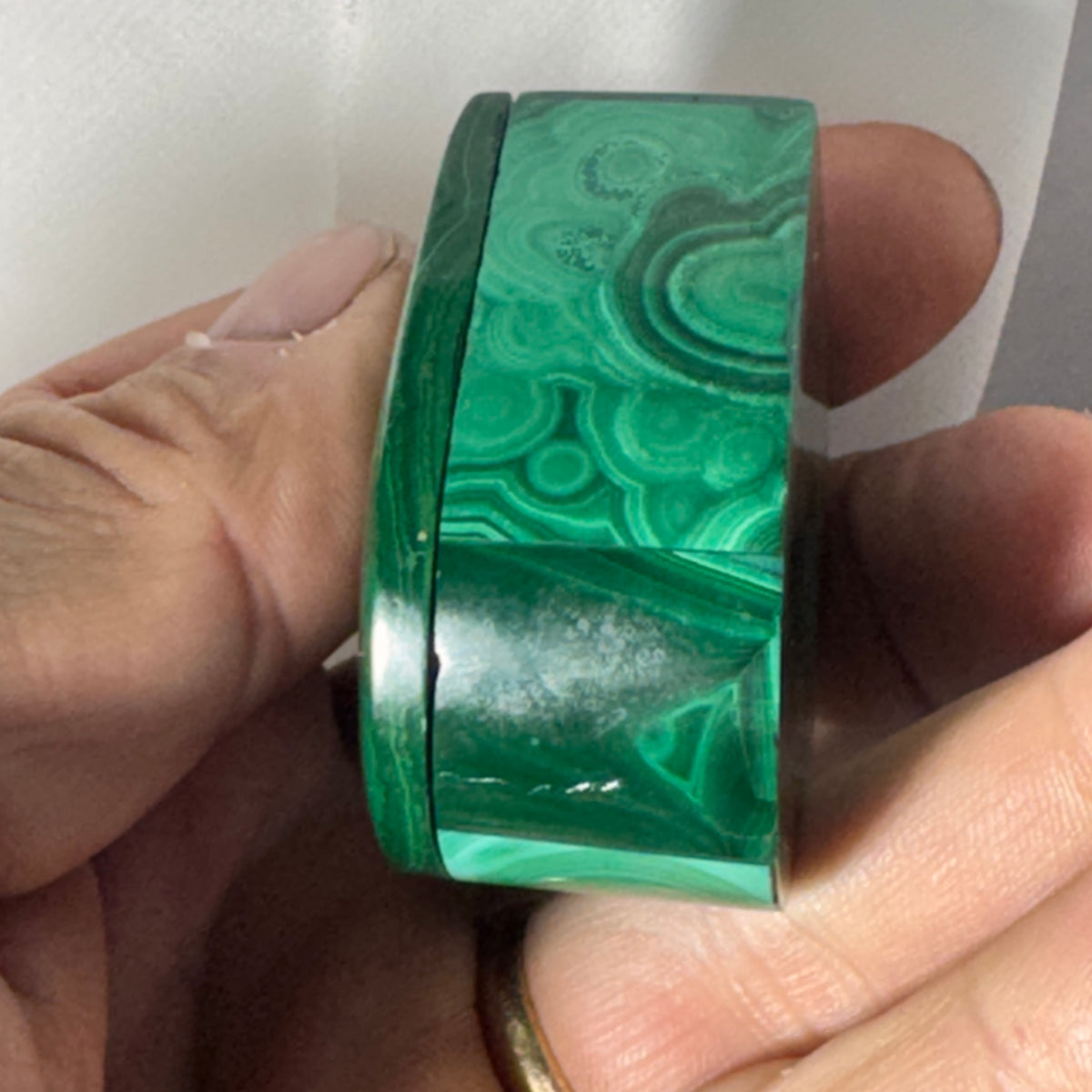 Malachite heart ring box side view with smooth green stone face and polished edge