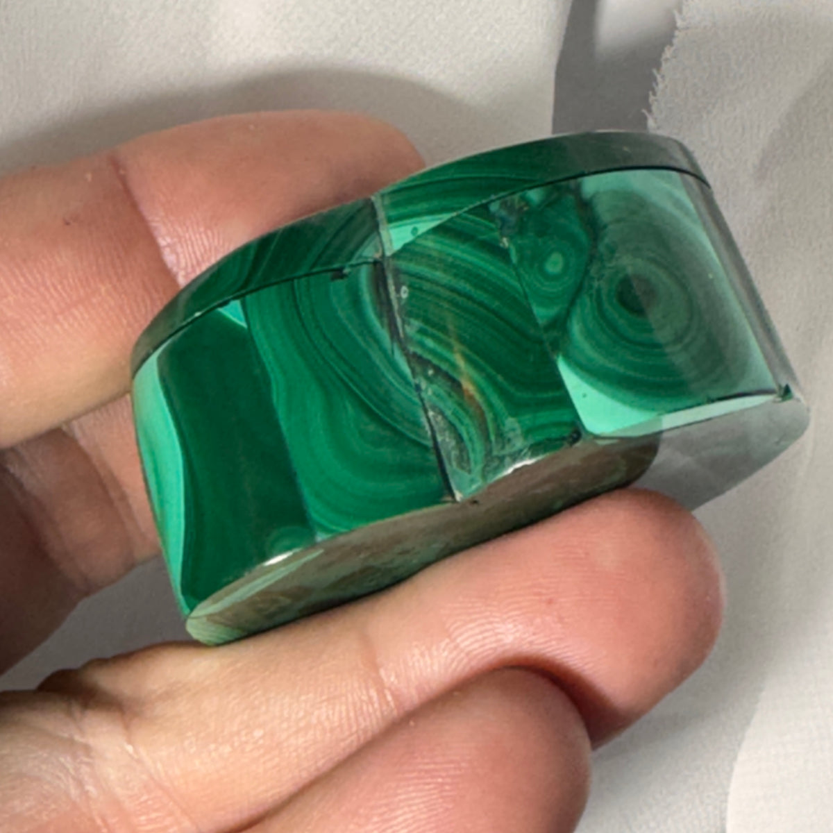 Malachite heart box angled close-up showing teal-green patterns and hinged lid seam