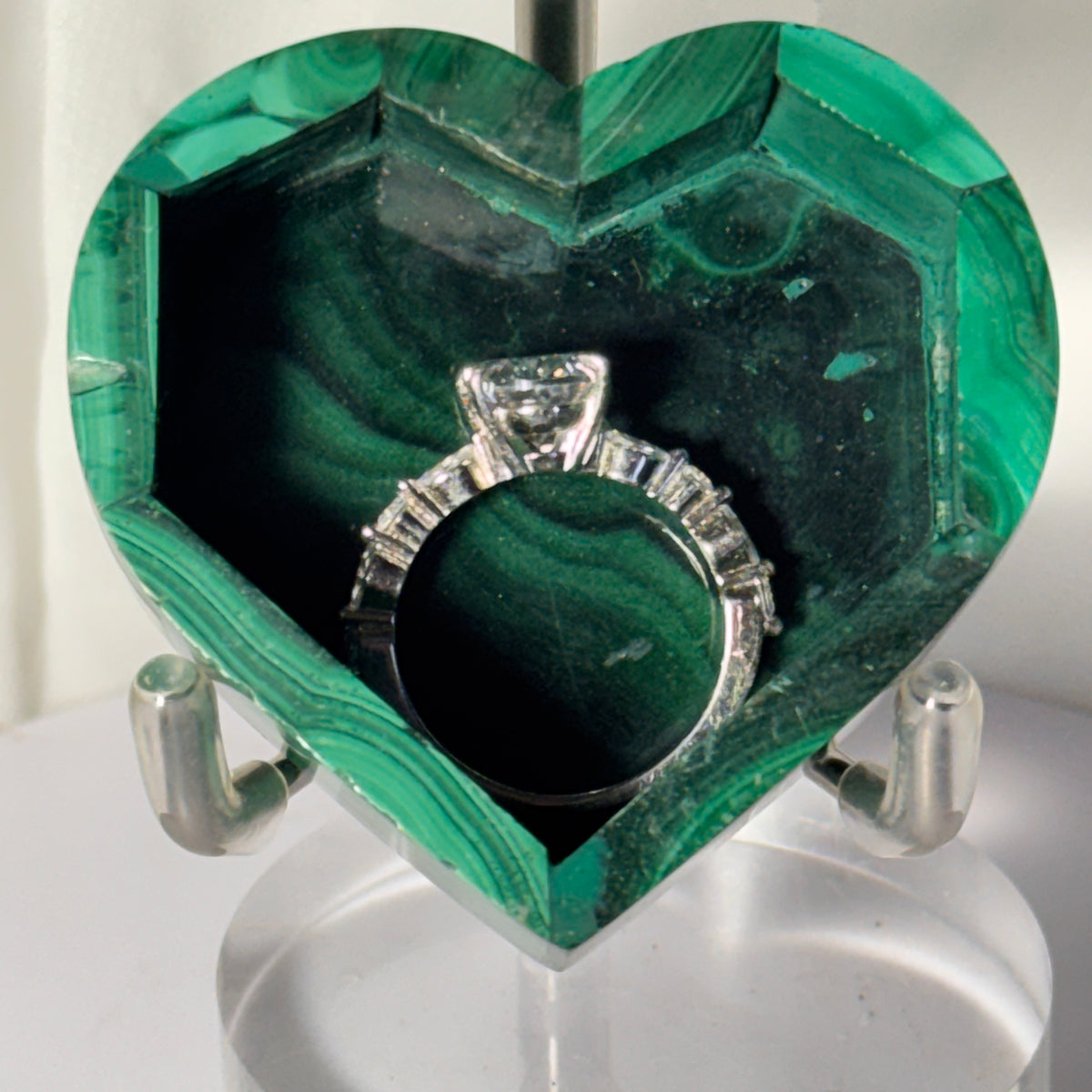 Open malachite heart trinket box with ring cushion holding a silver-tone ring