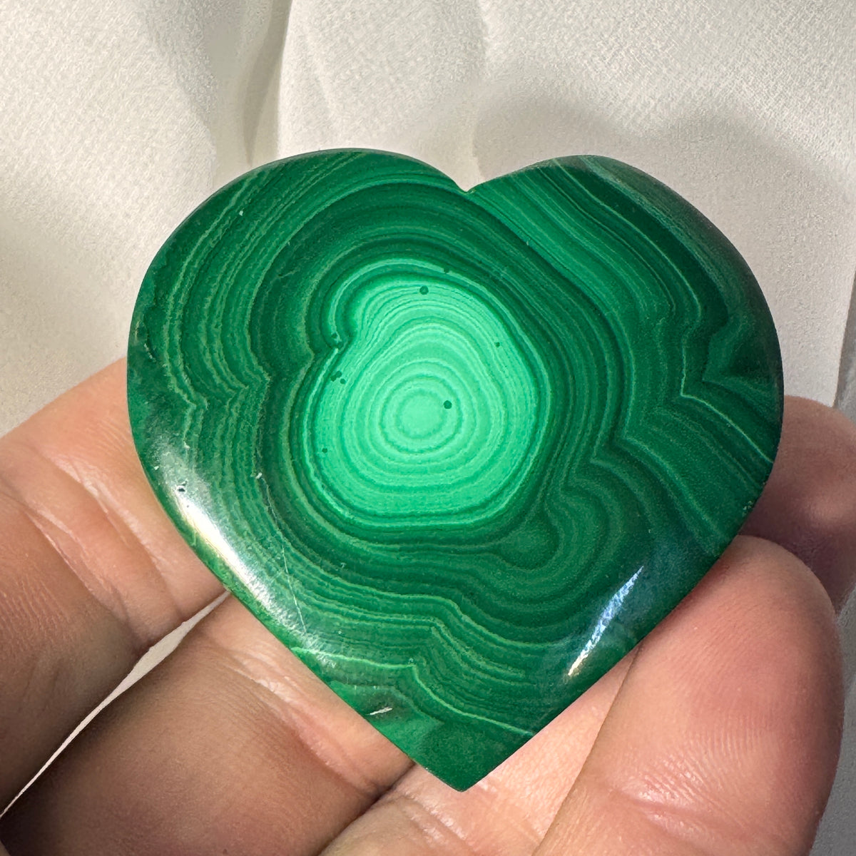 Green malachite heart jewelry box with bright center swirl and glossy finish