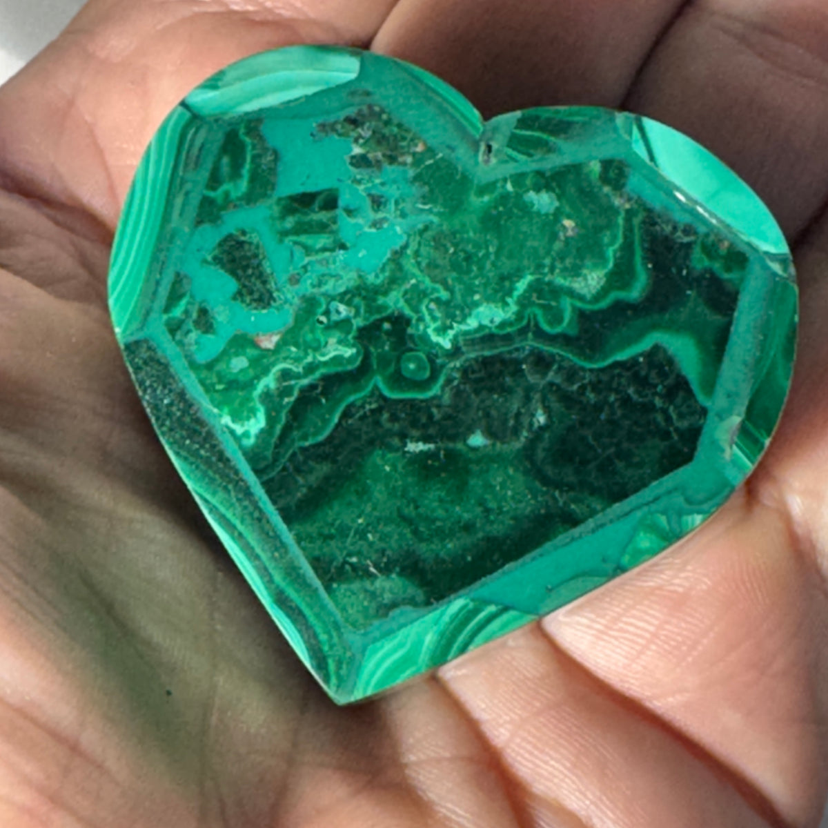 Malachite heart trinket box close-up showing layered green stone veining