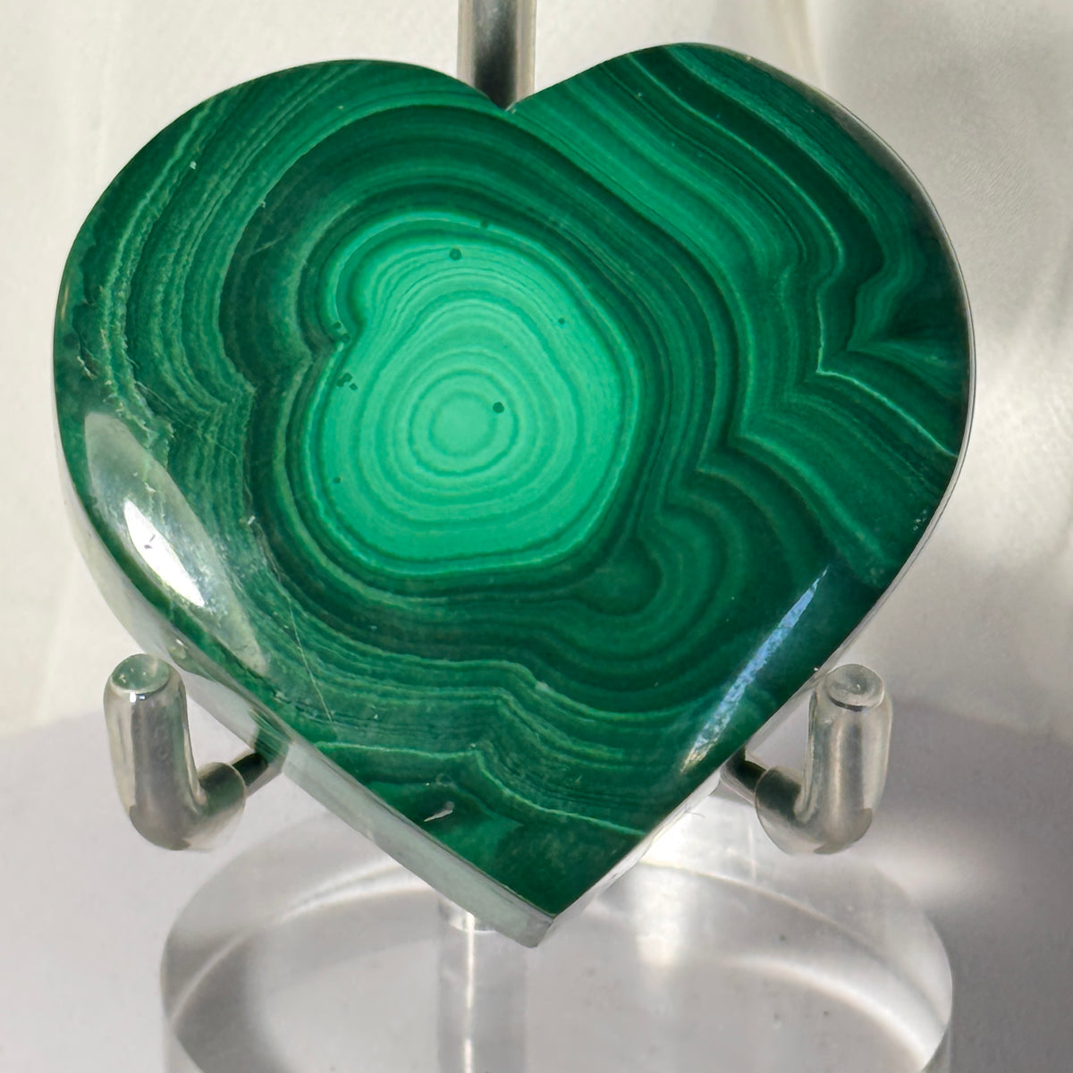 Heart-shaped malachite trinket box front view with concentric green swirl markings