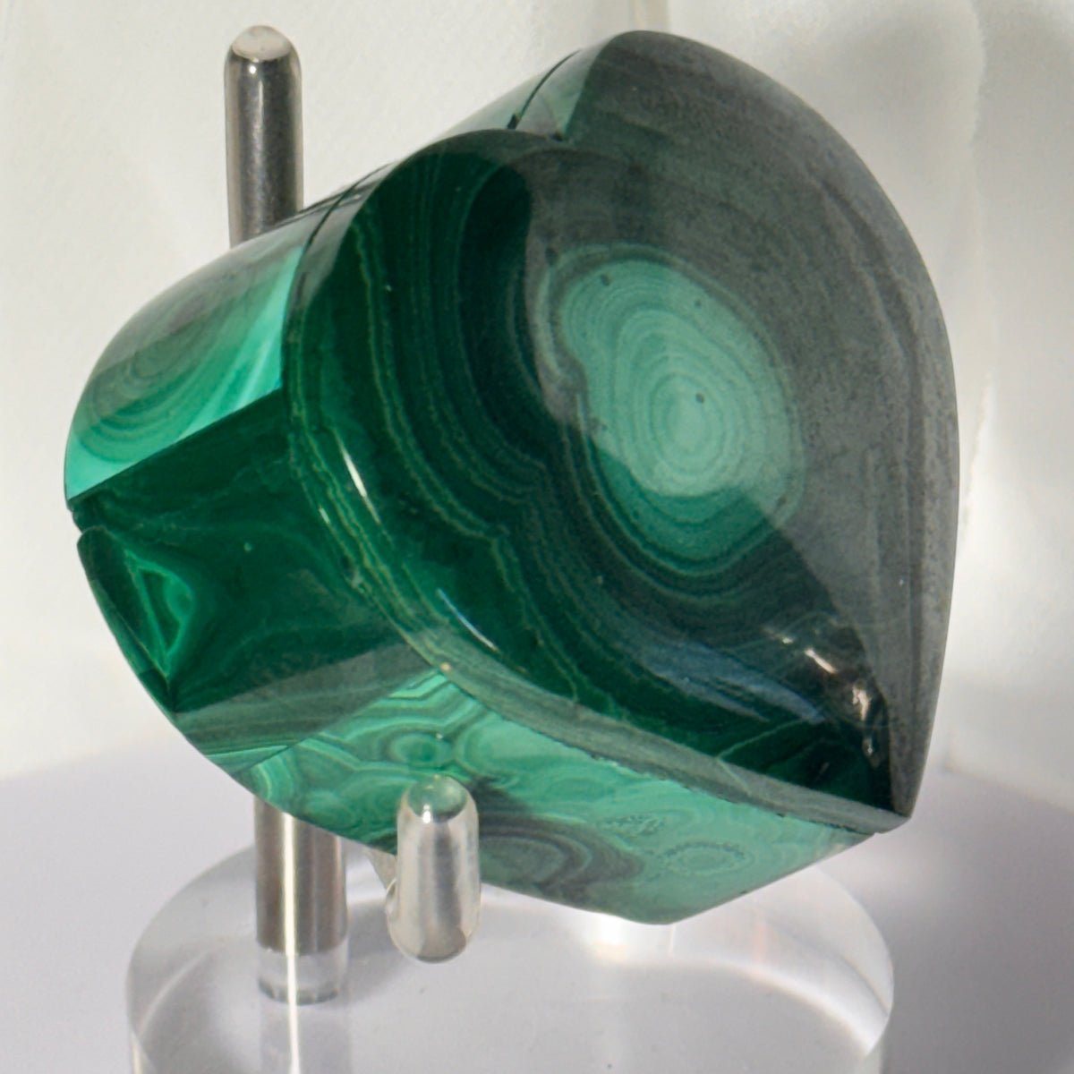 Heart-shaped malachite trinket box with glossy green stone lid on a silver stand