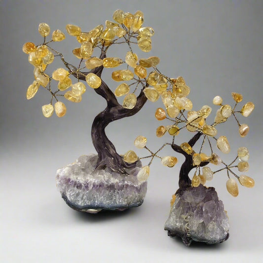 Two decorative gemstone bonsai trees with amethyst crystal bases and citrine branches.