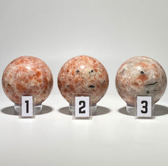 [shopname] - Sunstone sphere in acrylic stand, rock decor