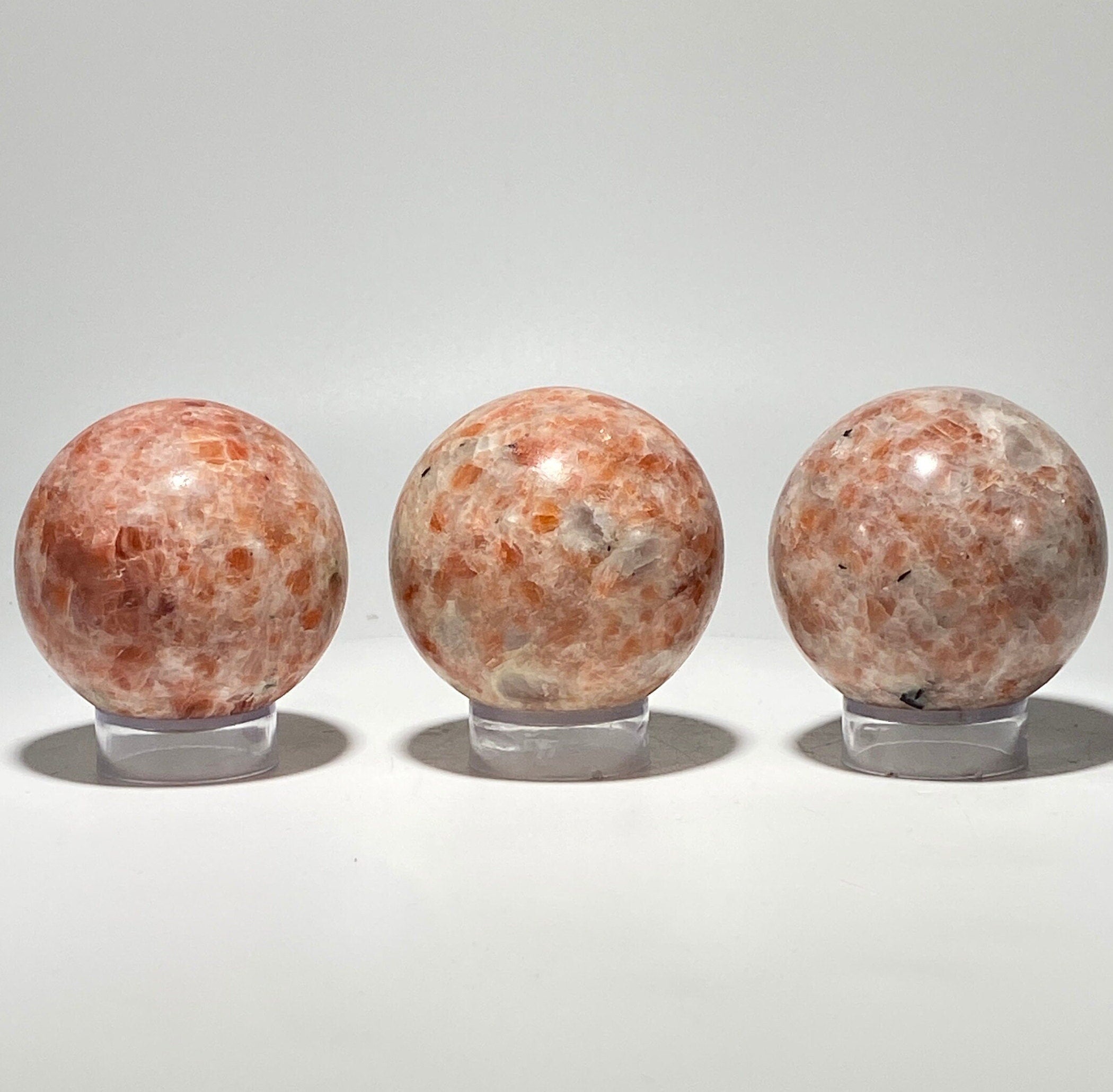 [shopname] - Sunstone sphere in acrylic stand, rock decor