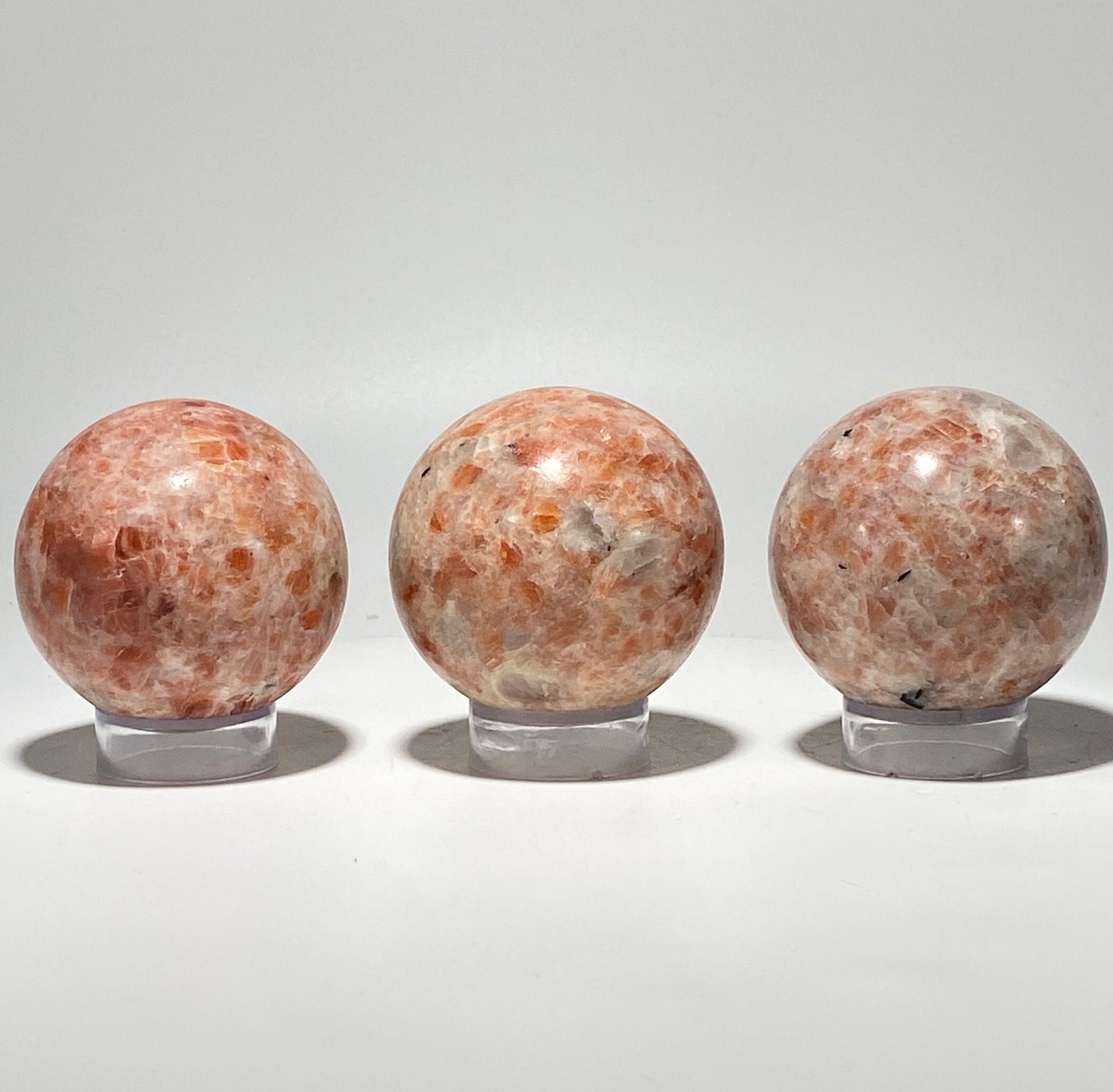 [shopname] - Sunstone sphere in acrylic stand, rock decor