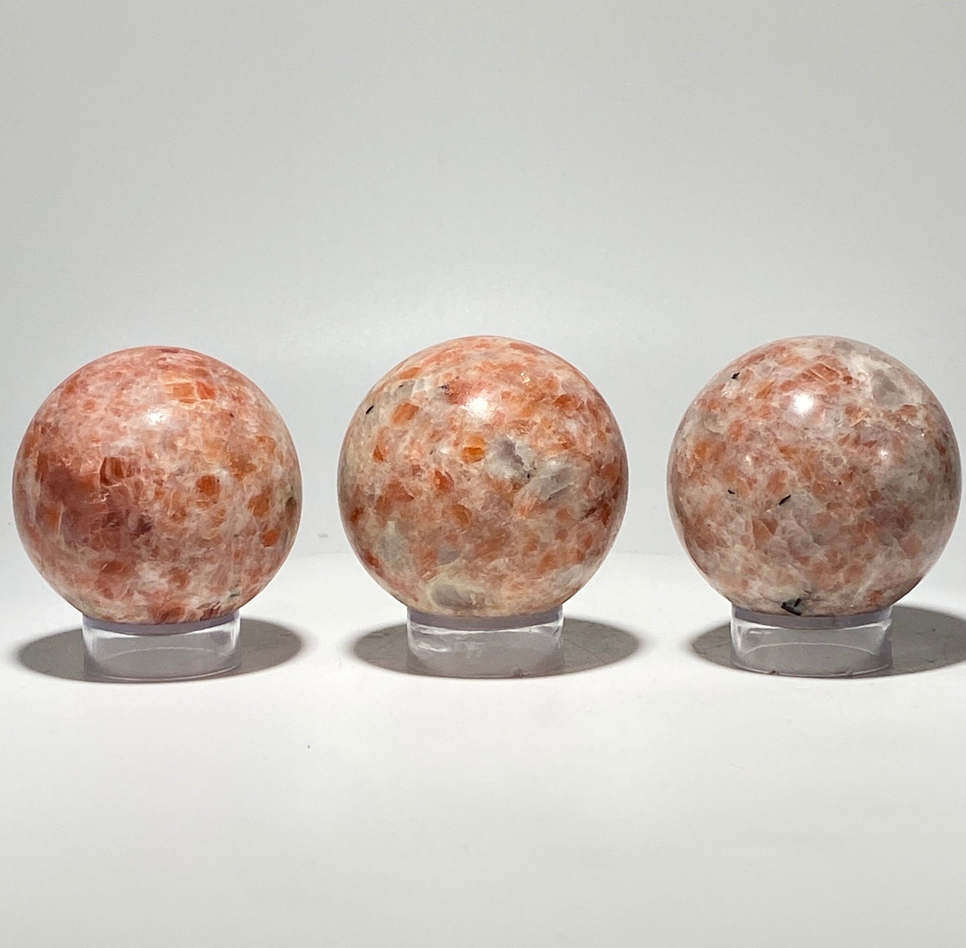 [shopname] - Sunstone sphere in acrylic stand, rock decor