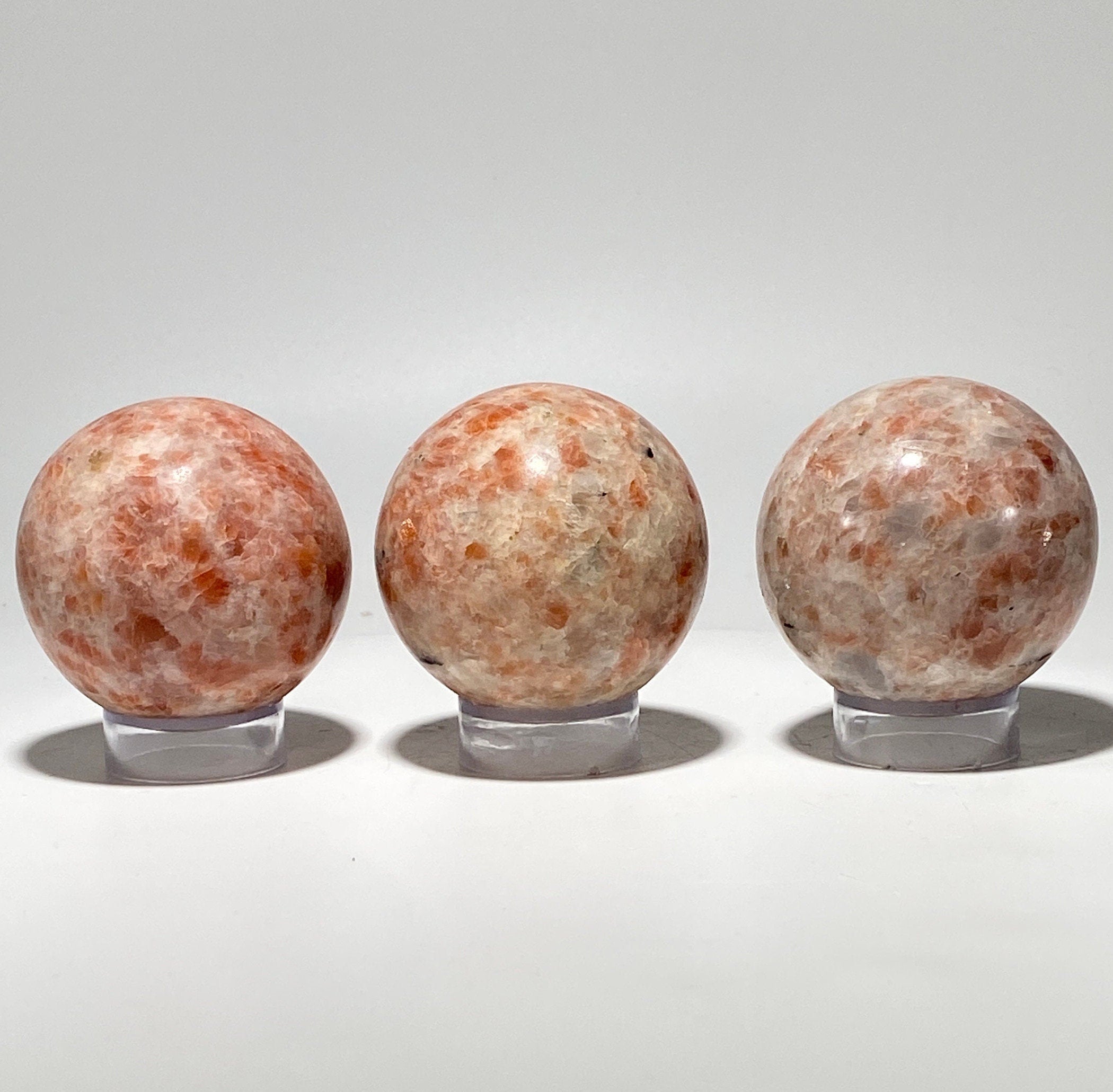 [shopname] - Sunstone sphere in acrylic stand, rock decor