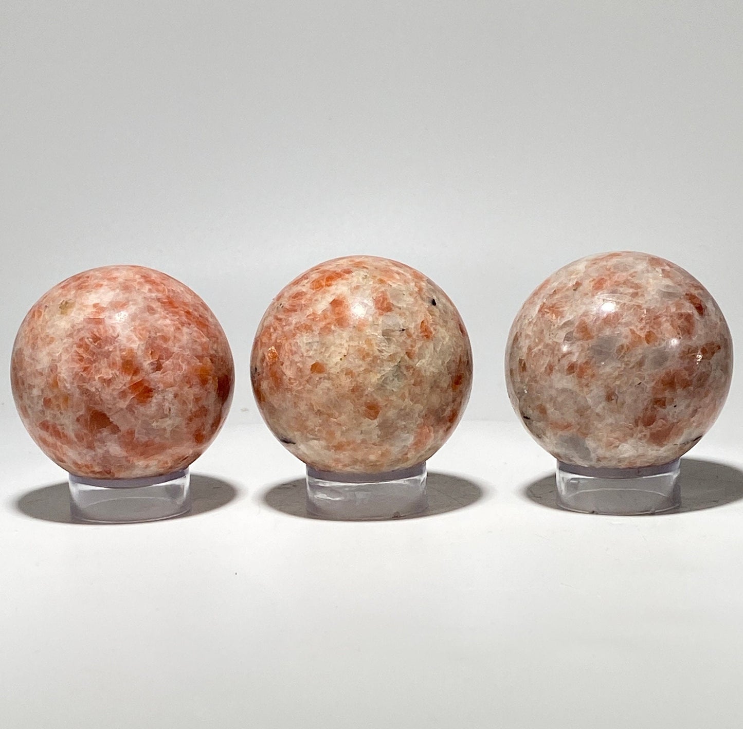 [shopname] - Sunstone sphere in acrylic stand, rock decor