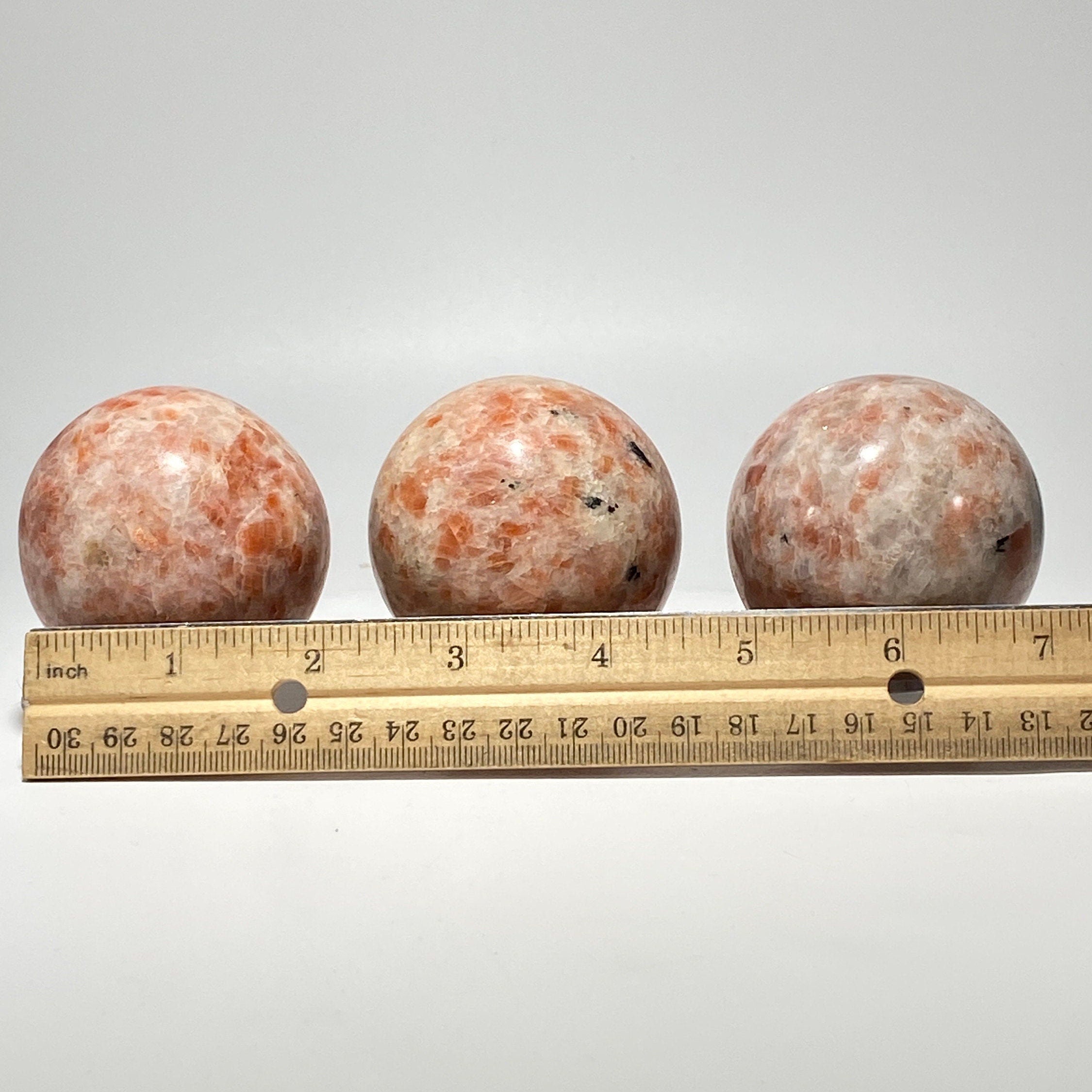 [shopname] - Sunstone sphere in acrylic stand, rock decor