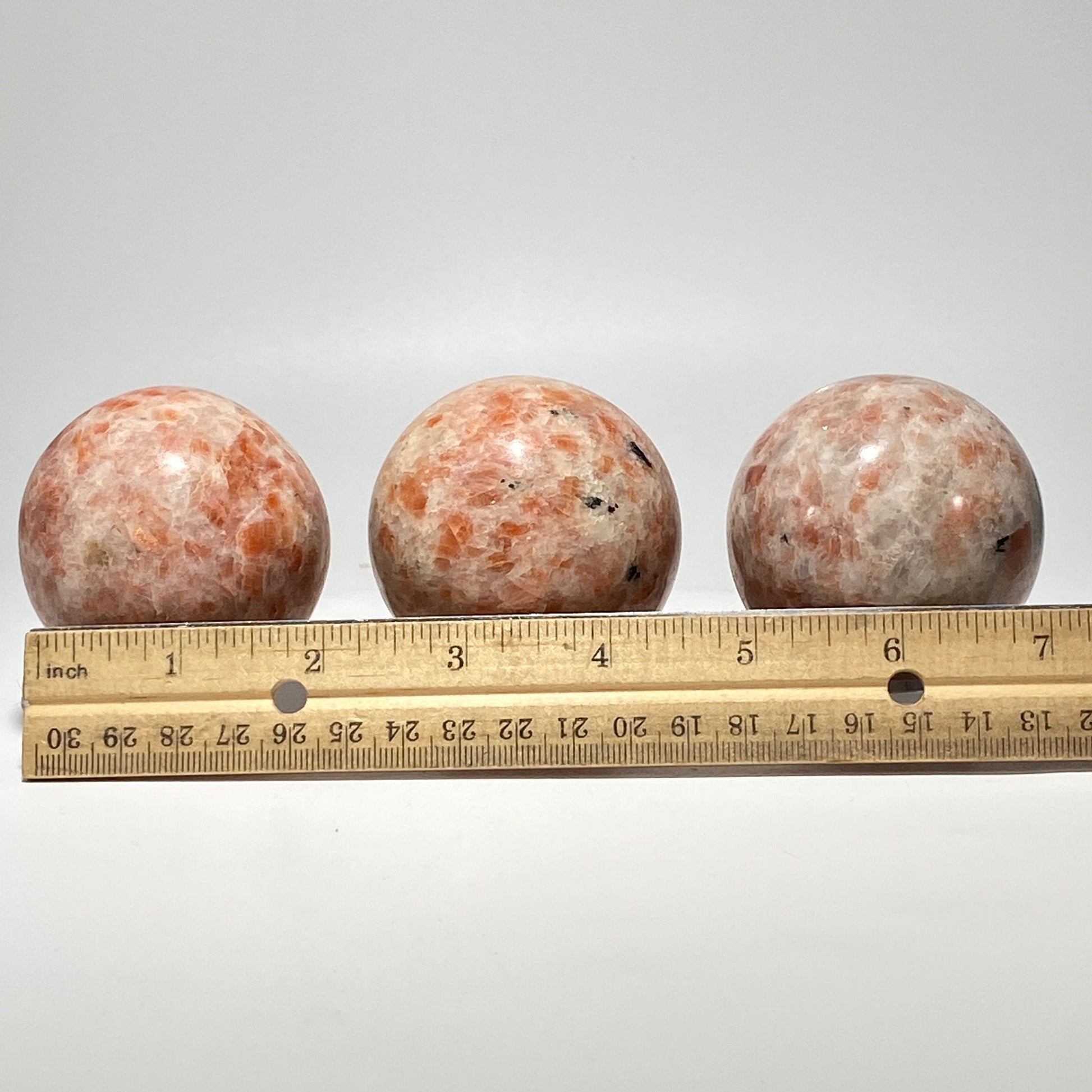 [shopname] - Sunstone sphere in acrylic stand, rock decor