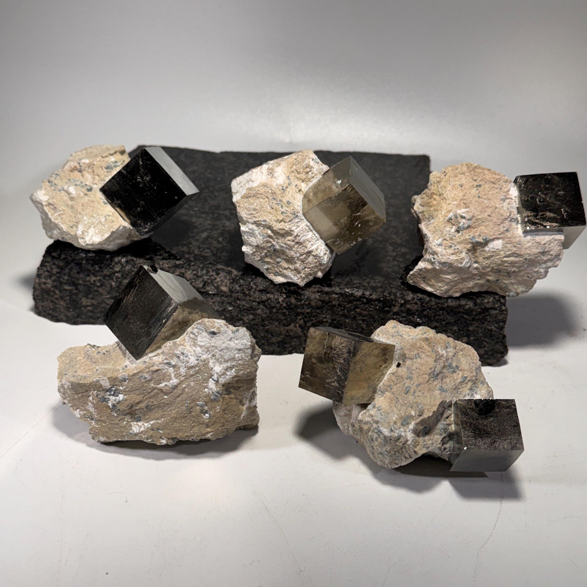Pyrite cube clusters in light tan matrix with dark metallic cube faces