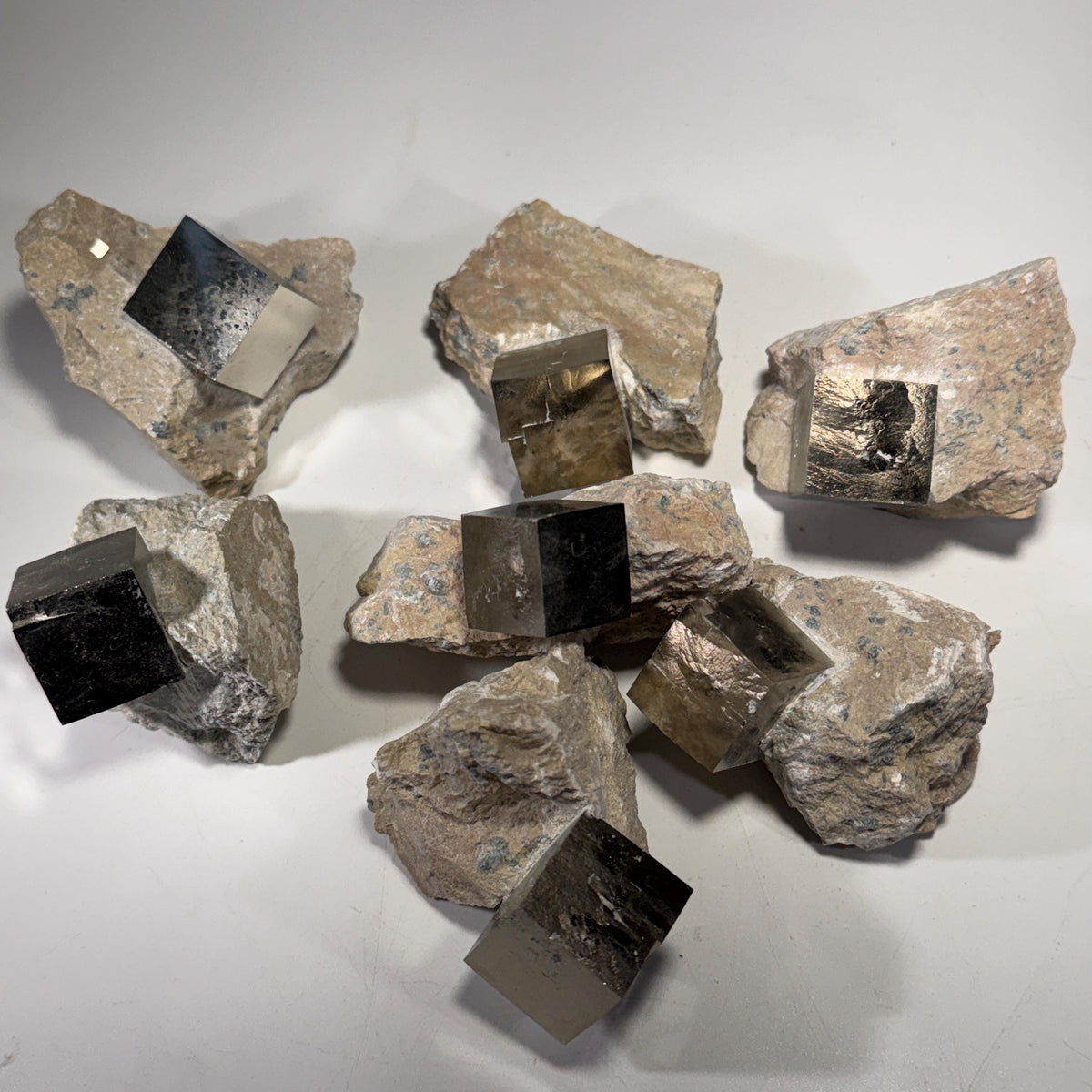 Pyrite crystal in matrix assortment with multiple dark, reflective cube faces