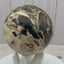 Black opal sphere in acrylic stand