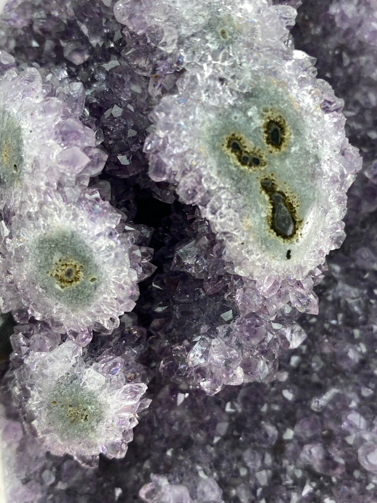 Amethyst geode with stalactite eyes