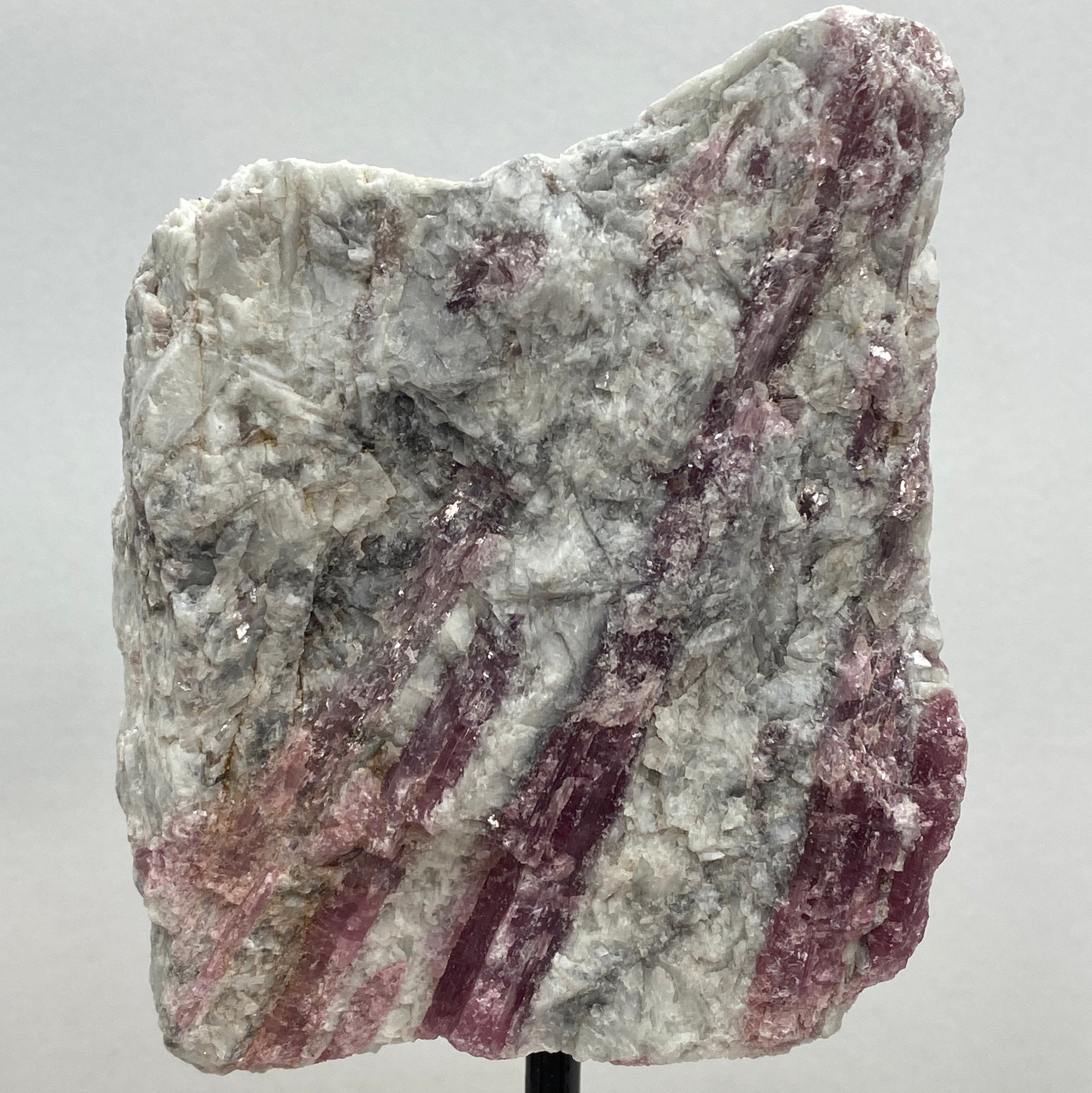 Pink tourmaline on a metal stand