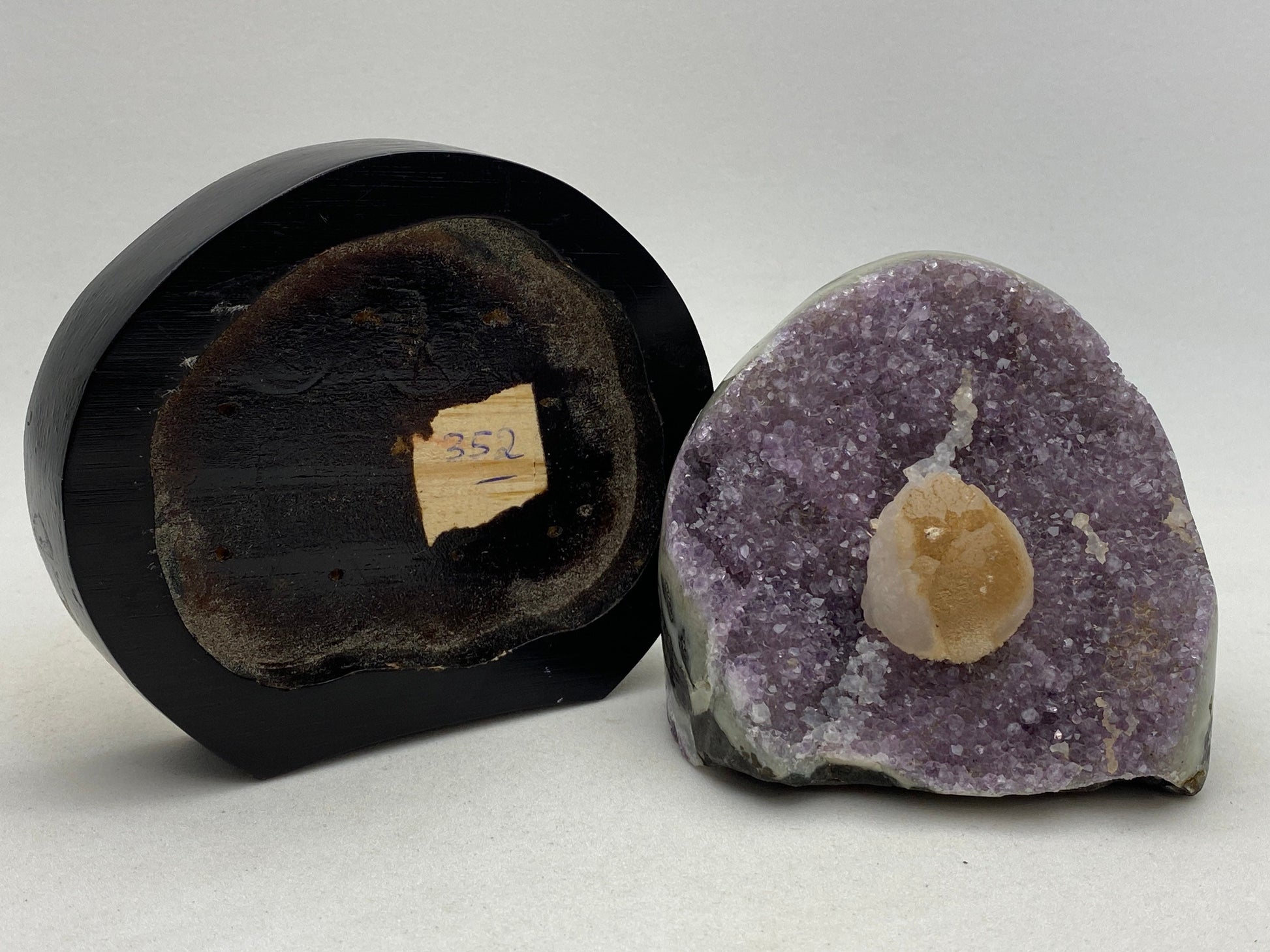 Amethyst geode cluster on a wood base