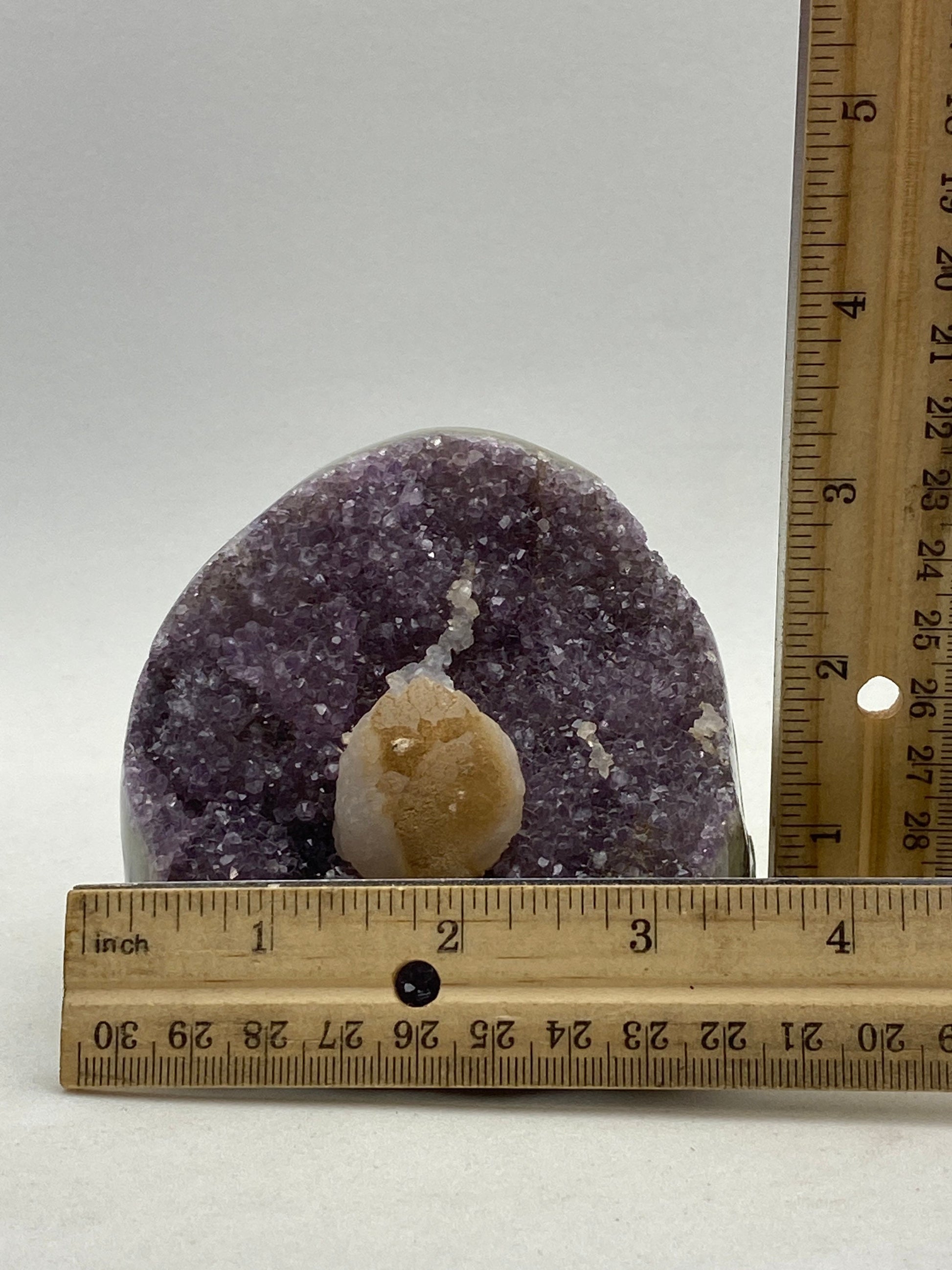 Amethyst geode cluster on a wood base