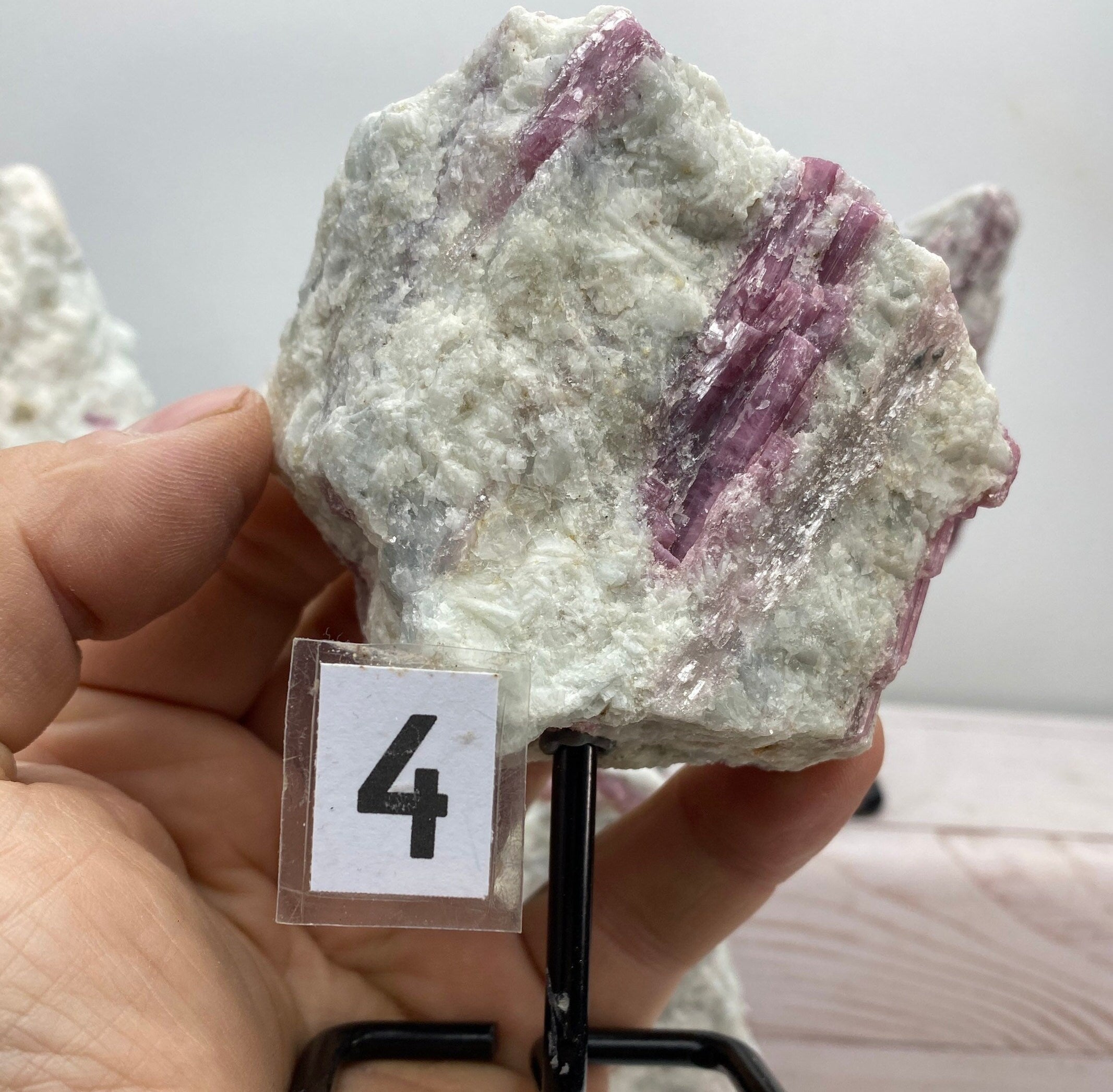 Pink tourmaline on a metal stand