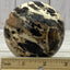 Black opal sphere in acrylic stand